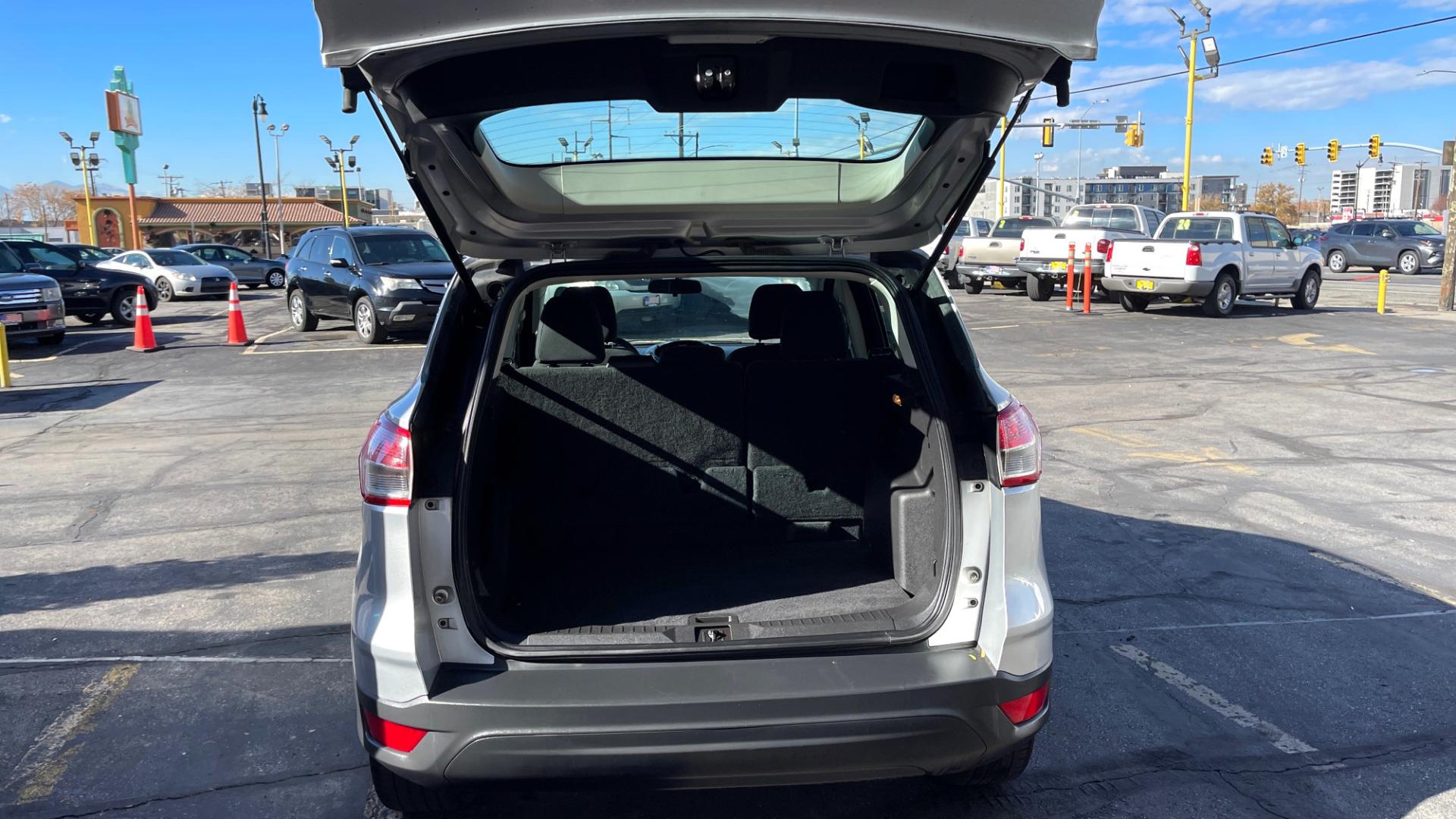 2014 Silver Sky Metallic /Black Ford Escape S (1FMCU0F75EU) with an 4 Cylinder 2.5L engine, AUTOMATIC transmission, located at 801 South State Street, Salt Lake City, UT, 84111, (801) 328-0098, 40.751953, -111.888206 - Perfect commuter car great gas mileage! FREE CAR FAX AND FREE AUTO CHECK on EVERY CAR know the car before you buy only at First Class Cars.Our service department is OPEN DAILY to help with any of your service needs. Please call for immediate appointment! Features: -ABS Brakes -AM/FM Stereo -Air C - Photo#12