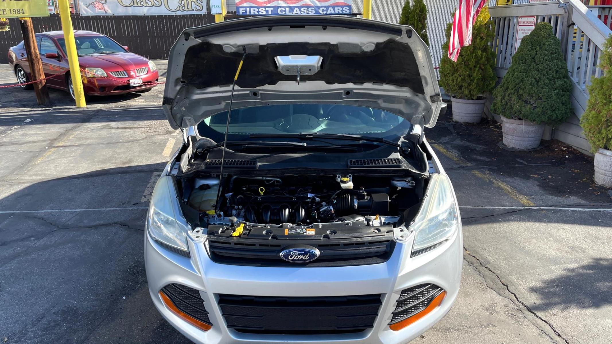 2014 Silver Sky Metallic /Black Ford Escape S (1FMCU0F75EU) with an 4 Cylinder 2.5L engine, AUTOMATIC transmission, located at 801 South State Street, Salt Lake City, UT, 84111, (801) 328-0098, 40.751953, -111.888206 - Perfect commuter car great gas mileage! FREE CAR FAX AND FREE AUTO CHECK on EVERY CAR know the car before you buy only at First Class Cars.Our service department is OPEN DAILY to help with any of your service needs. Please call for immediate appointment! Features: -ABS Brakes -AM/FM Stereo -Air C - Photo #10